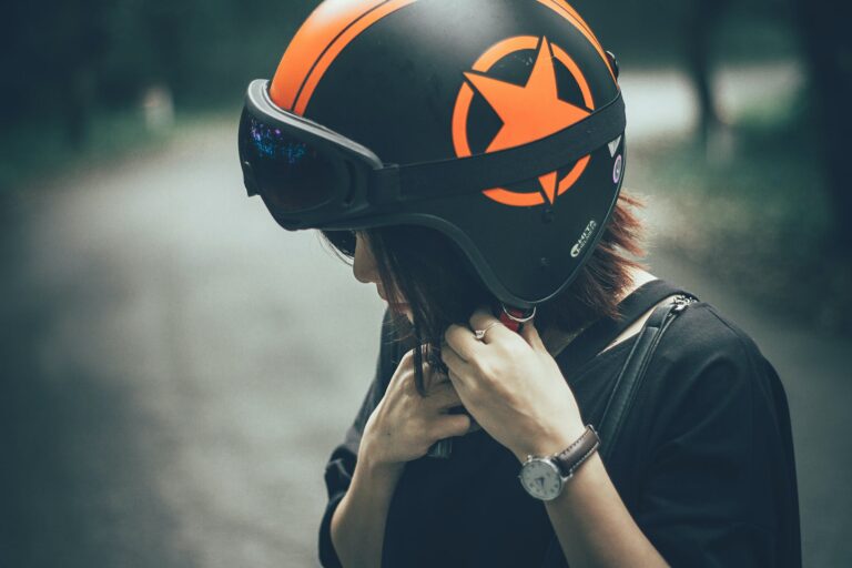 woman on black and orange half face helmet